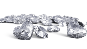 Heart-shaped and regular diamonds pile - a luxurious collection showcasing diamond shapes and brilliance. This signifies a Luxury Doodle Breeder.